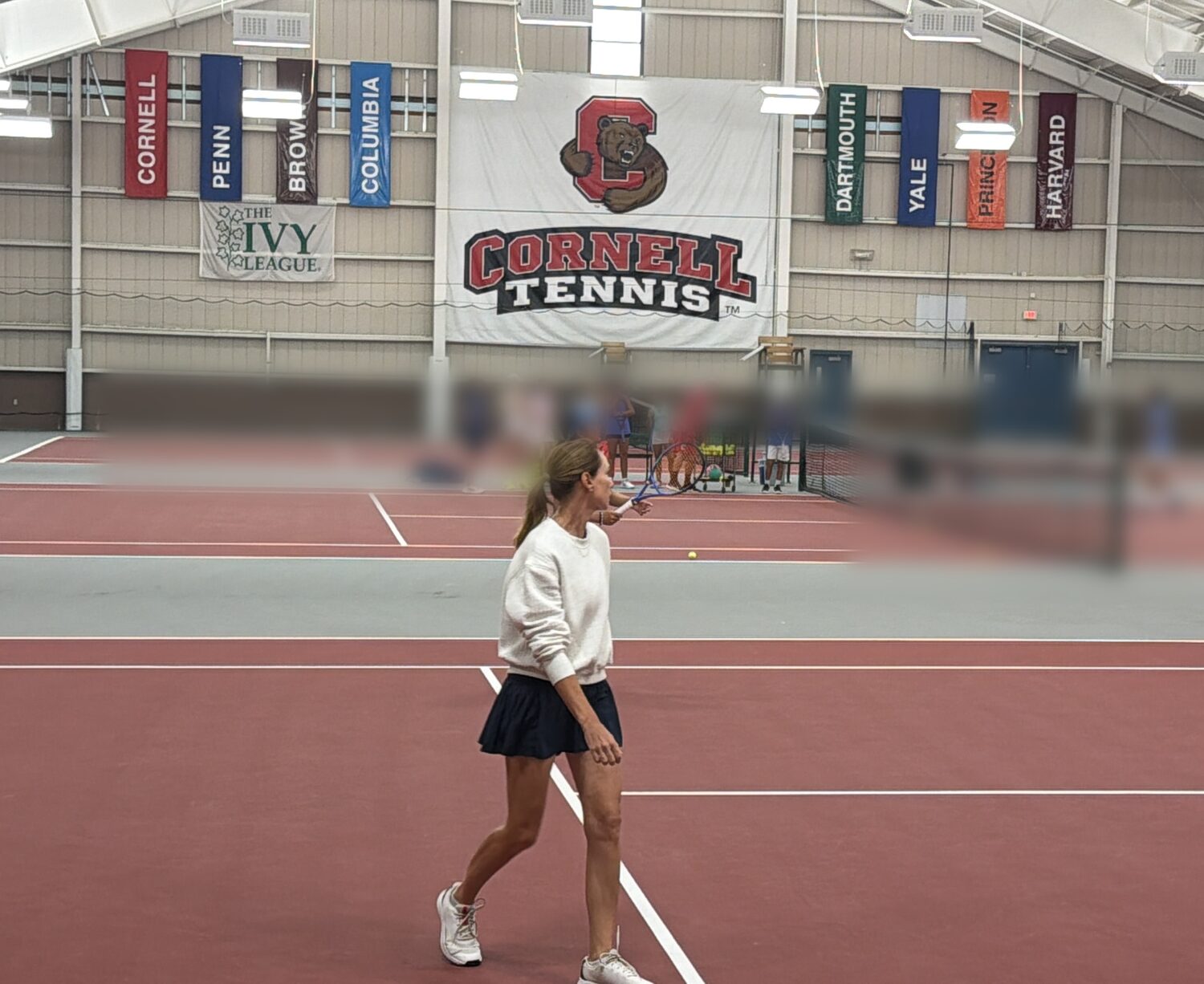 Alina Jidkova coaching on court at the Cornell University Tennis Camp, Reis Tennis Center in Ithaca, New York